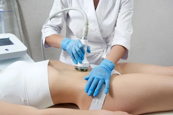 Lost the Weight but Not the Loose Skin? 2 woman having HIFU treatment on her stomach to combat loose skin Hampshire following weight loss